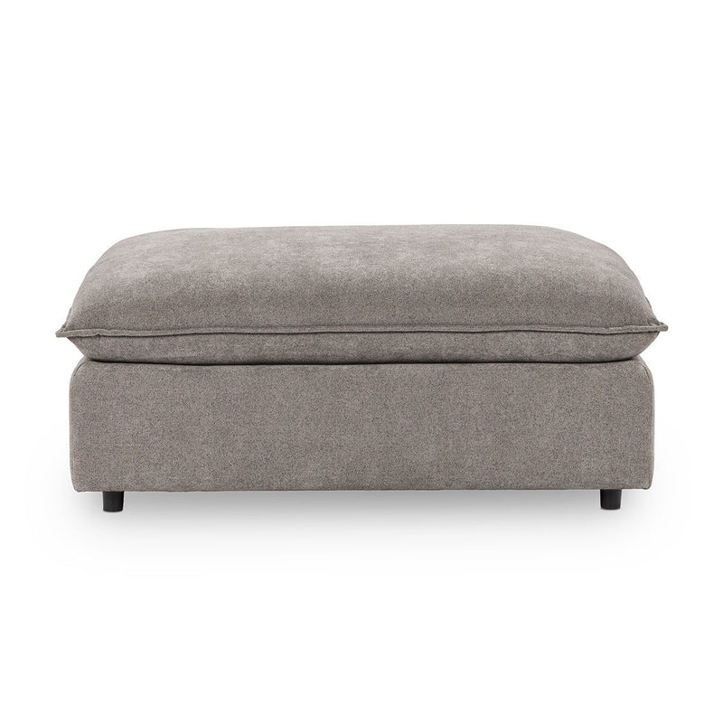 Upholstered ottoman in medium gray fabric, rounded top, short legs and seams