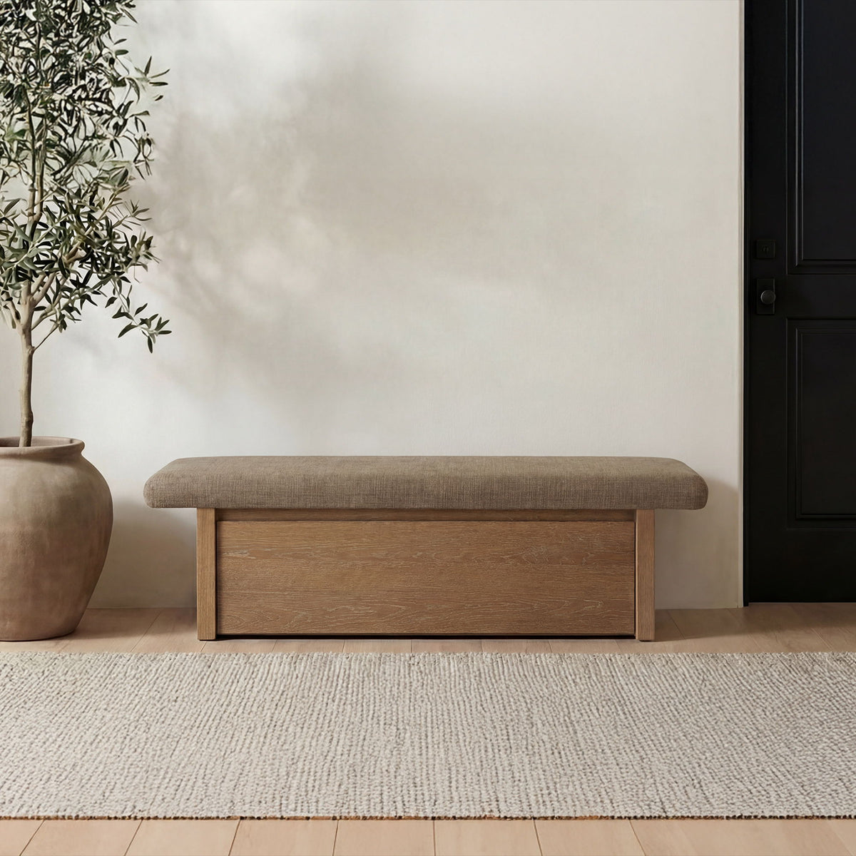 Taupe upholstered storage bench with padded top and front wooden storage door