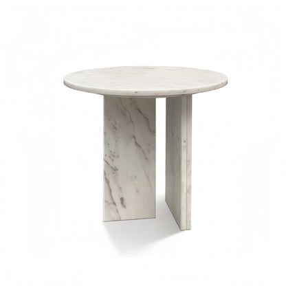 Round white stone coffee table with marble-like veining and tall rectangular pedestal legs