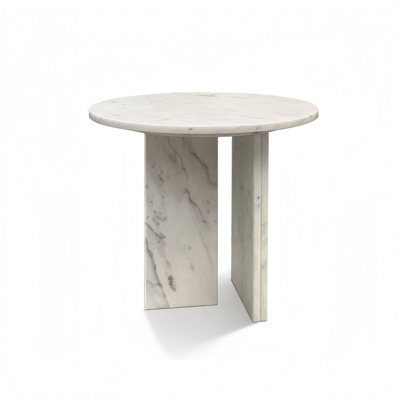 Round white stone coffee table with marble-like veining and tall rectangular pedestal legs