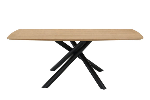 Light wood dining table with rounded edge and black crossed legs, close side view