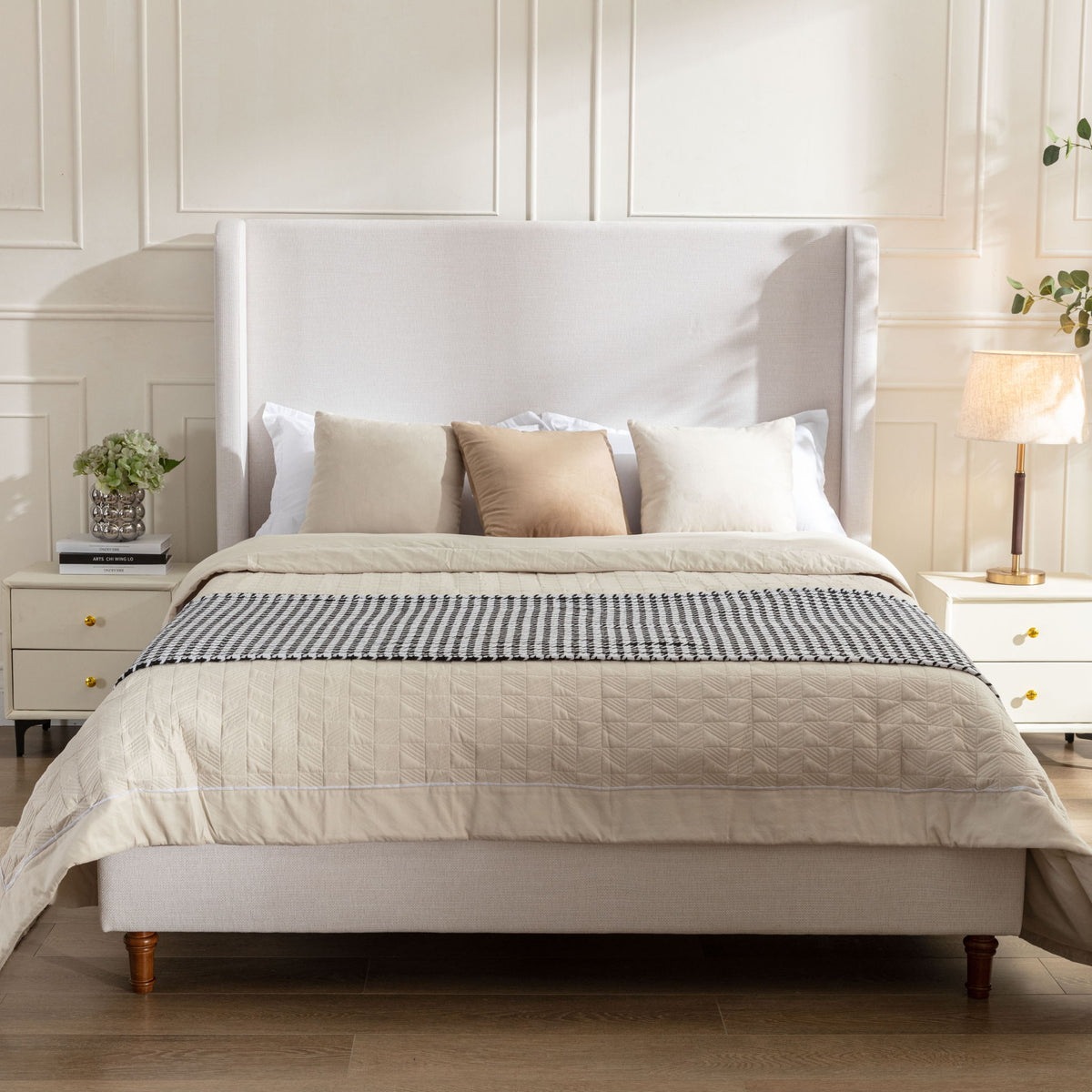 Ivory upholstered king bed with tall wingback headboard and wooden feet