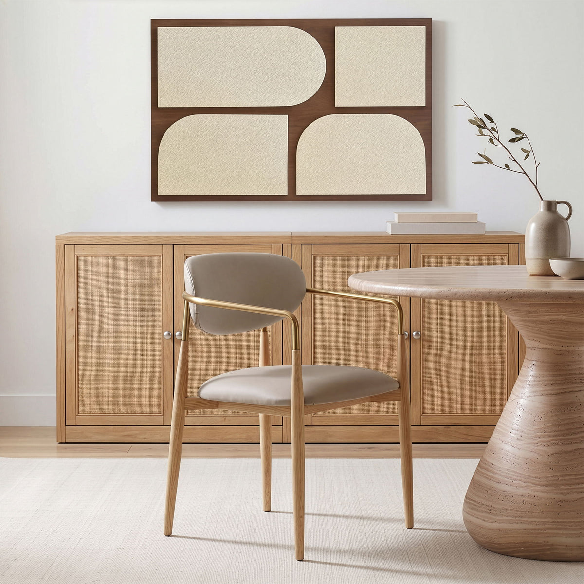 Vegan leather dining arm chair with gray seat, curved gold-tone armrests, natural wood legs