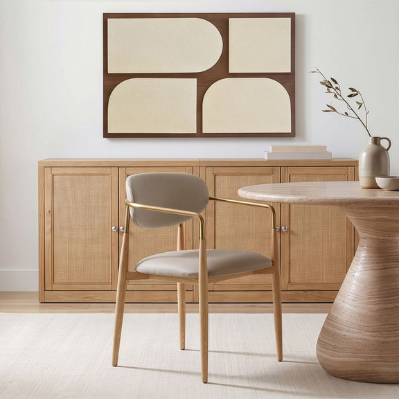 Vegan leather dining arm chair with gray seat, curved gold-tone armrests, natural wood legs