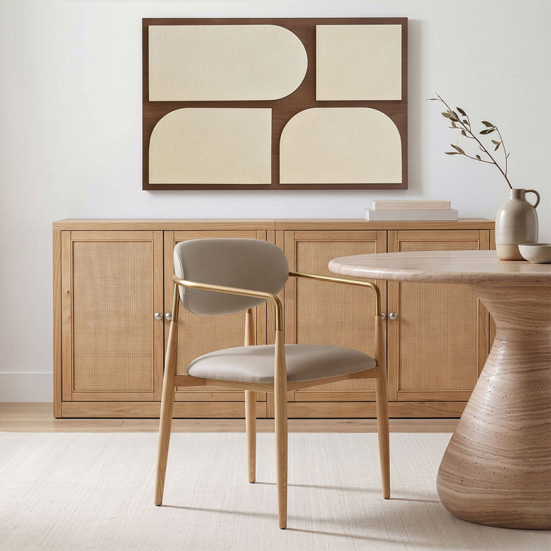 Vegan leather dining arm chair with gray seat, curved gold-tone armrests, natural wood legs