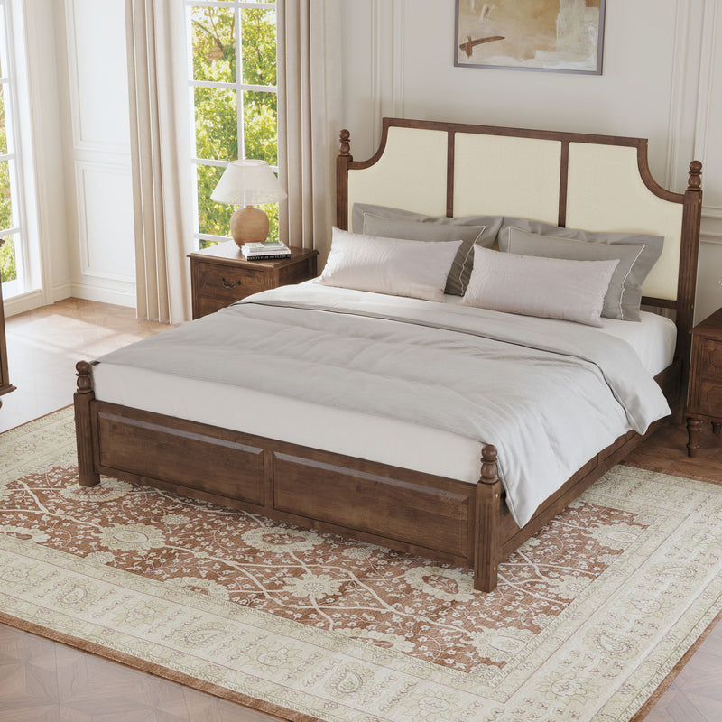 Upholstered platform bed with tall headboard, brown frame, cream panels, made bed