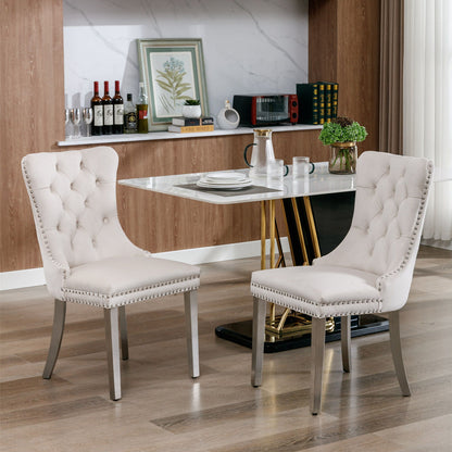 Cream white tufted upholstered dining chairs with nailhead trim and padded seats