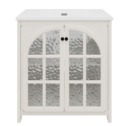 White farmhouse bathroom vanity with ceramic sink and arched glass-paneled cabinet doors