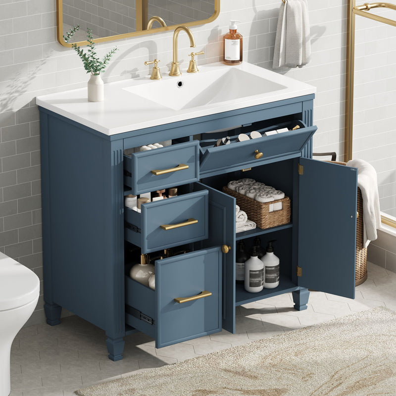 Blue bathroom vanity with white sink and open drawers with gold pulls