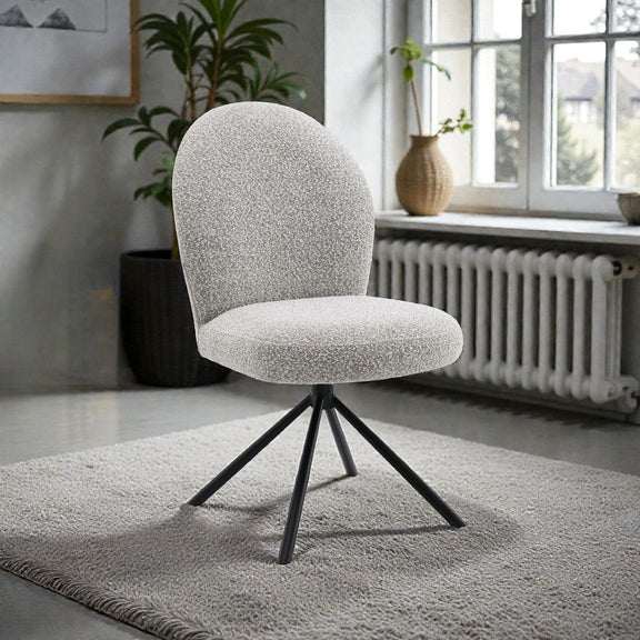 Gray upholstered swivel side chair with rounded back and black four-leg base