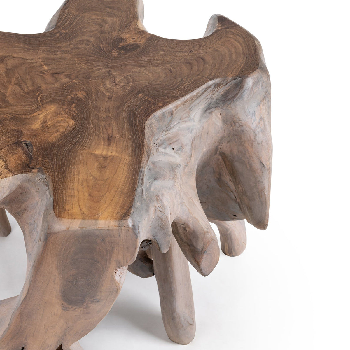 Root end table angled view with mixed-toned slab top and four tapered root legs