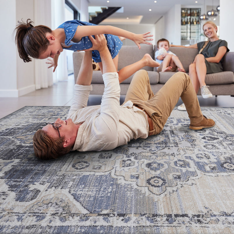 Cream and blue medallion area rug featuring distressed tile-and-damask pattern