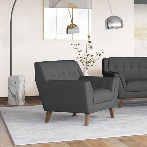 Dark gray accent chair with tufted backrest and padded arms, on wooden legs
