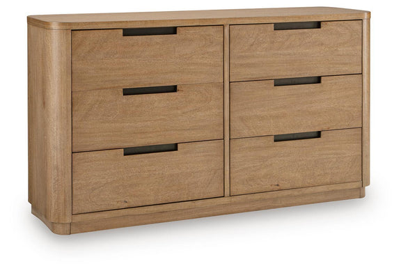 Light brown wood dresser with four drawers and black bar pulls