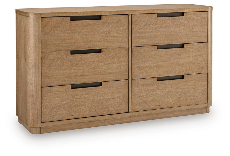 Light brown wood dresser with four drawers and black bar pulls