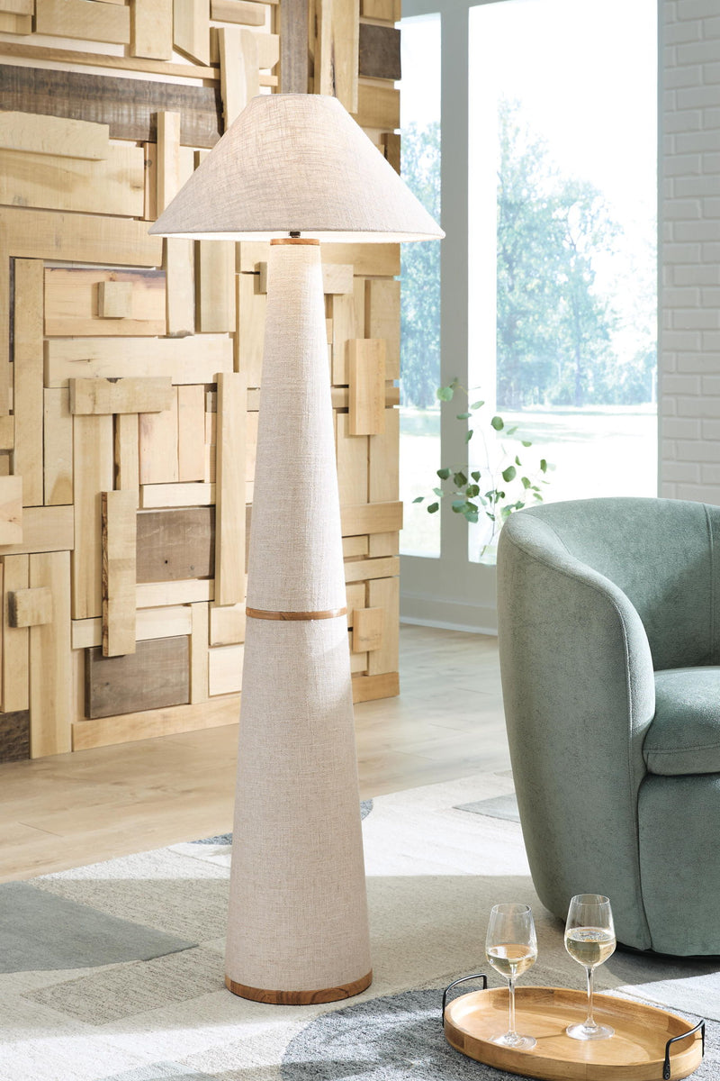Beige fabric floor lamp with conical shade and tall metal pedestal base, wood-tone ring