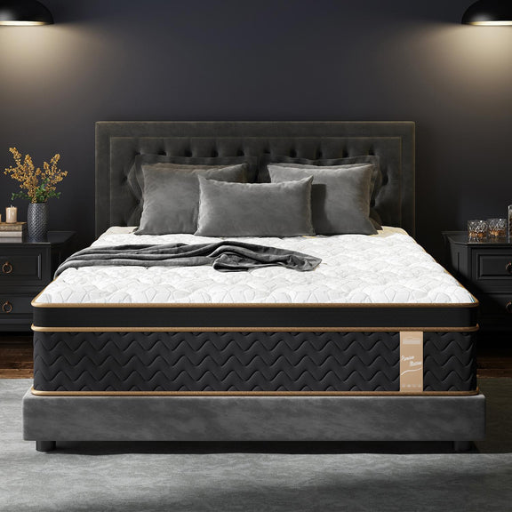 Hybrid mattress on dark bed frame, white quilted top with black sides and gold edge trim