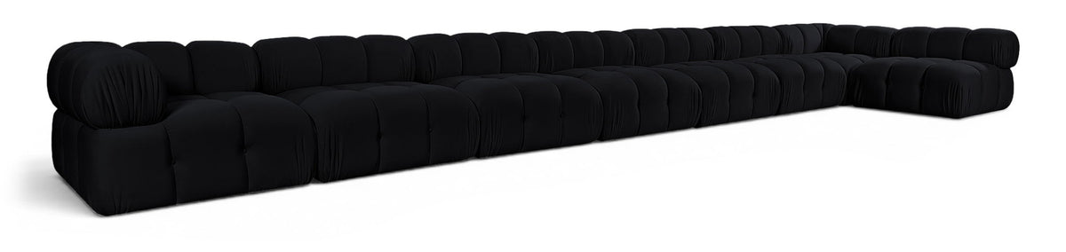 L-shaped velvet sectional sofa in black with tufted cushions and rolled arm details