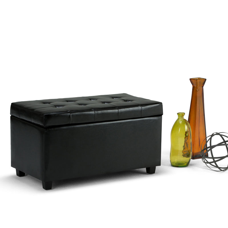 Midnight black storage ottoman with tufted lid and sturdy block legs