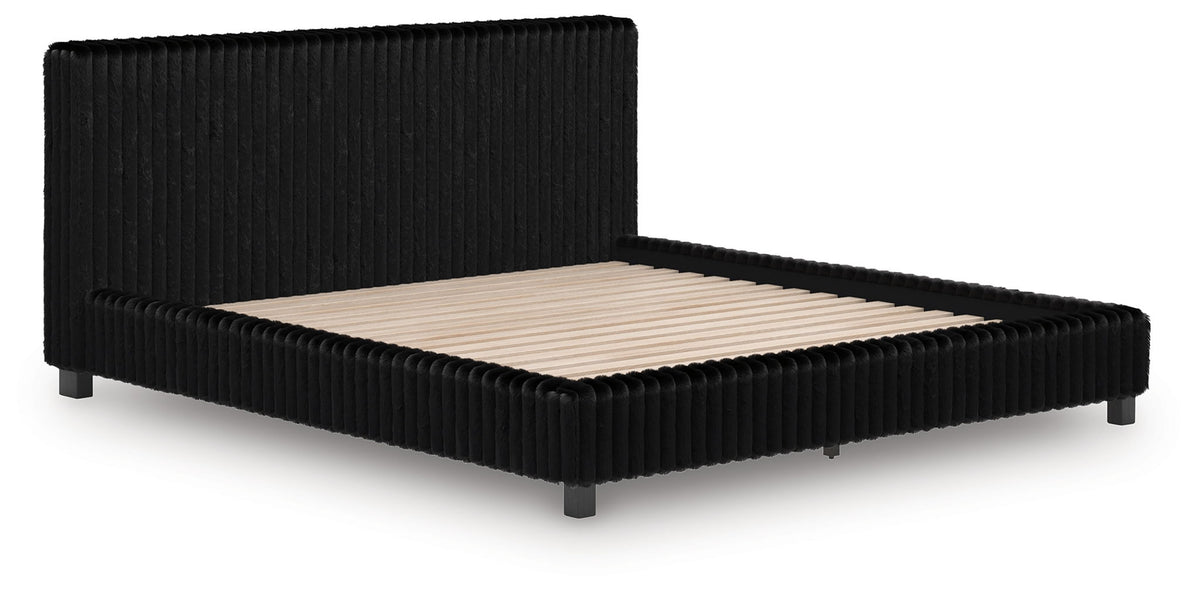 Black upholstered bed frame with ribbed sides and beige mattress, low profile