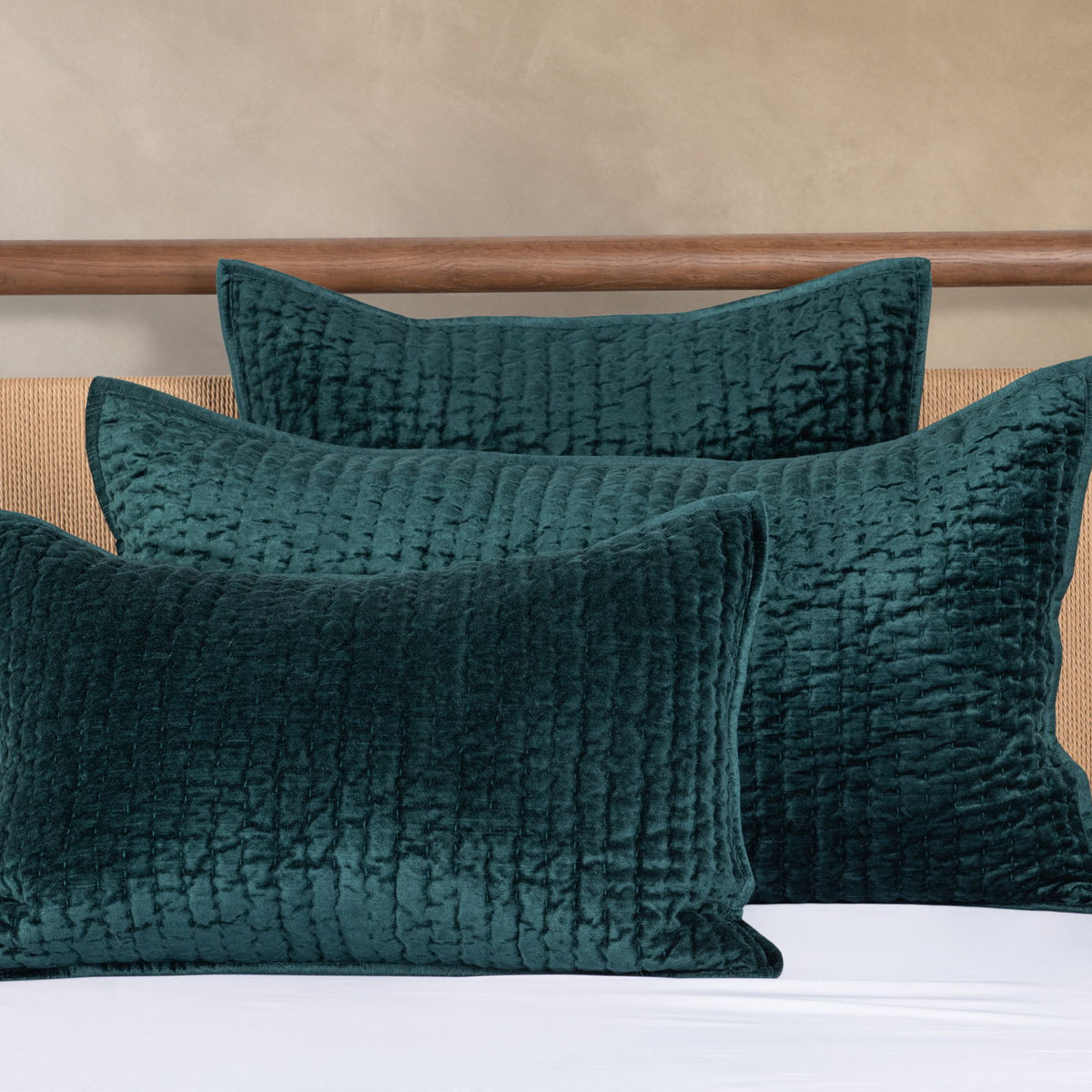 Teal velvet quilt set with two textured square pillows and matching quilt