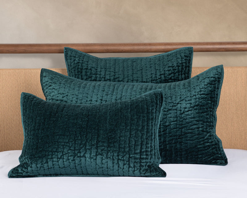Teal velvet quilt set with two textured square pillows and matching quilt