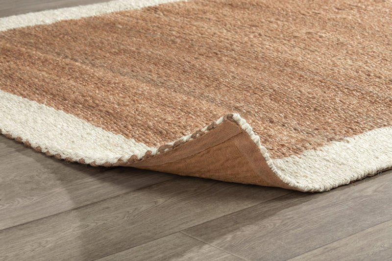 Frame area rug corner detail with ivory edge and tan top, showing folded pile
