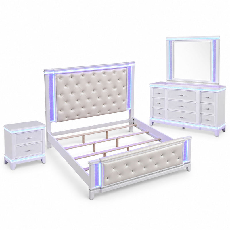 White bedroom set with tufted headboard, bed frame, nightstand and dresser with mirror.
