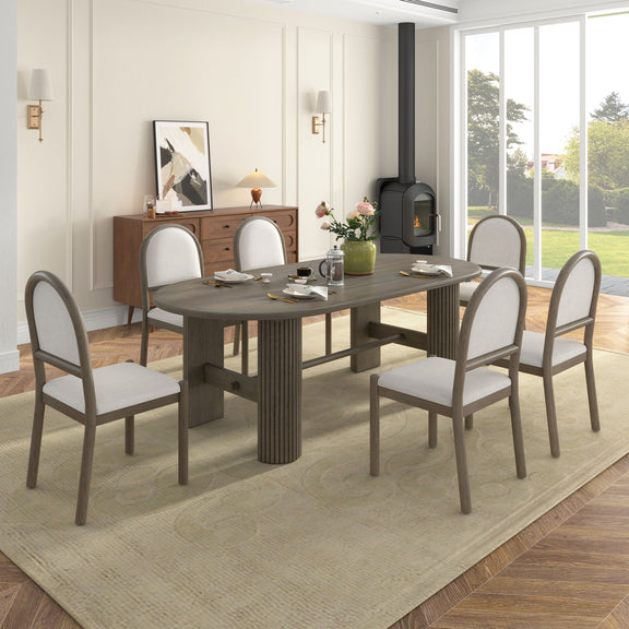 Dark brown oval dining table with six upholstered chairs, fabric seats and rounded arched backs