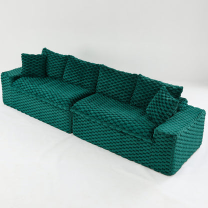 Multifunctional sofa in teal green with tufted cushions and backrest, side angle view.