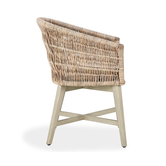 Outdoor dining chair side view, woven wicker shell and beige padded seat