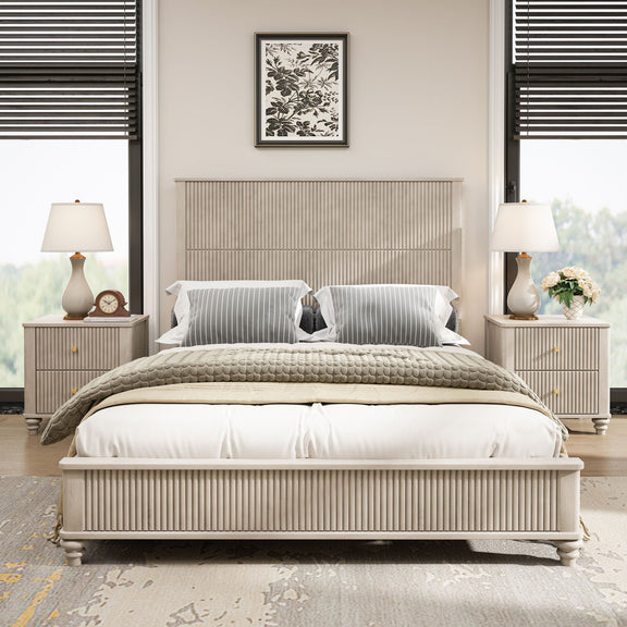 Beige upholstered bed with striped pillows and two matching nightstands with lamps