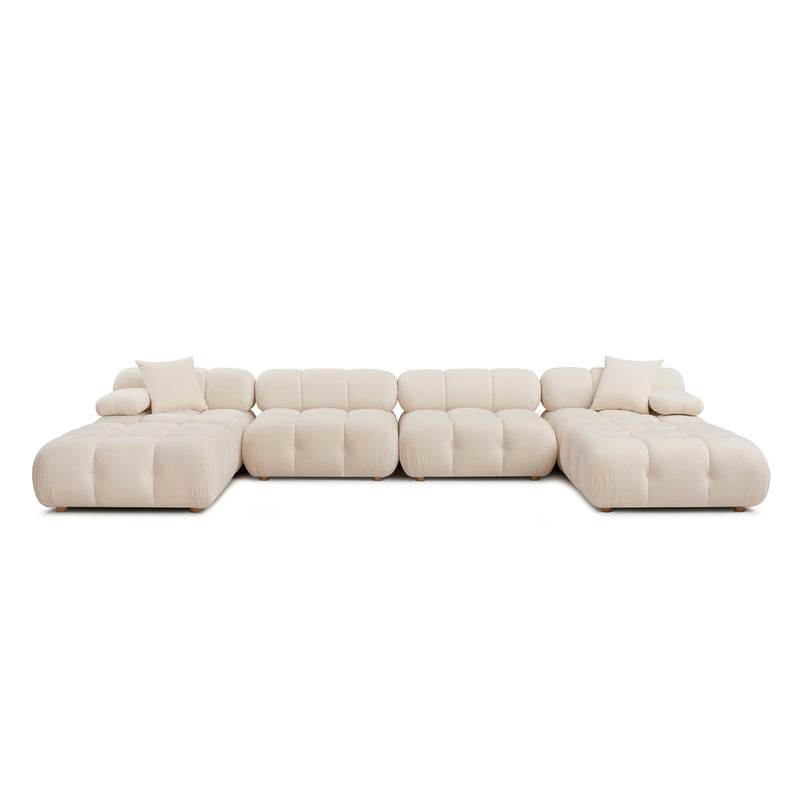 Light beige modular sectional sofa with chaise and multiple padded seat sections