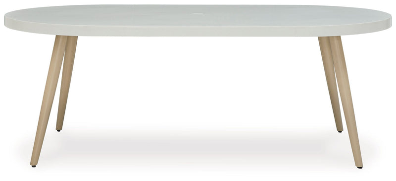 White oval dining table with slim legs and smooth tabletop