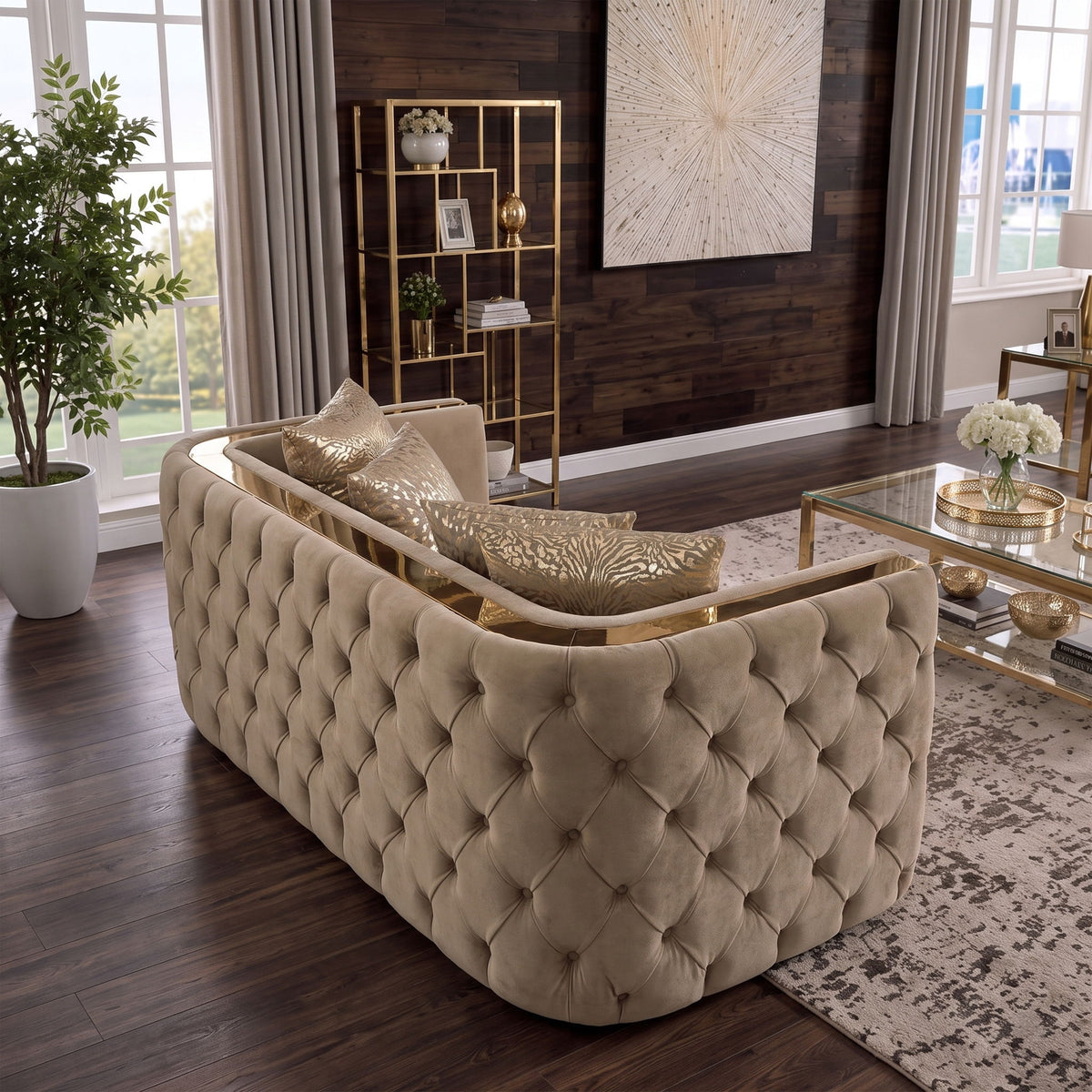 Light brown button-tufted loveseat with gold-tone side rails and patterned throw pillows
