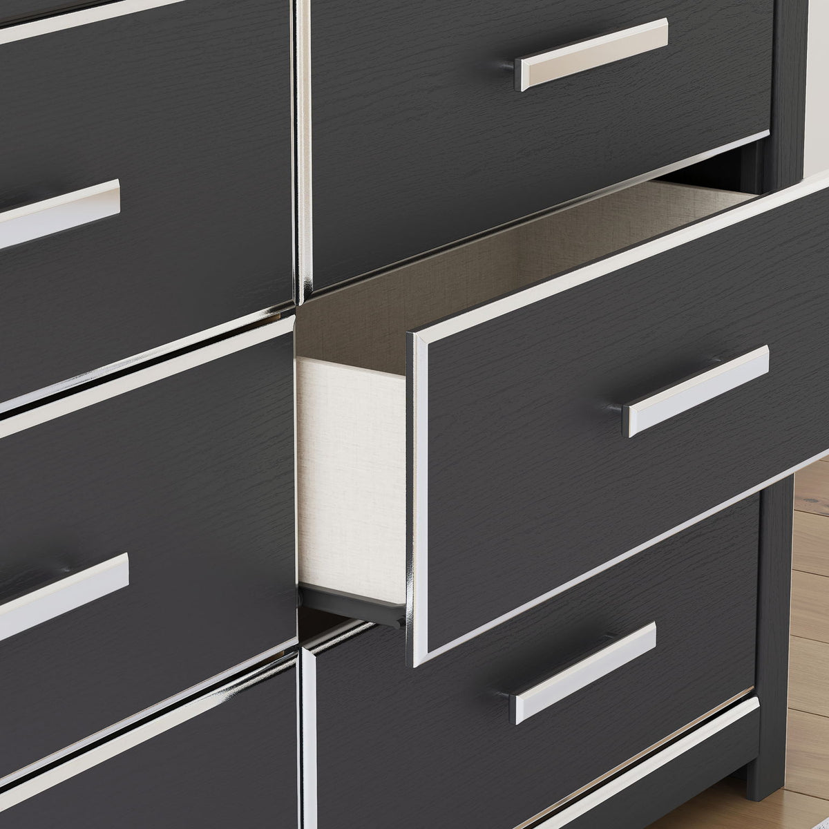 Six-drawer dresser close-up showing dark drawer fronts and white bar pulls