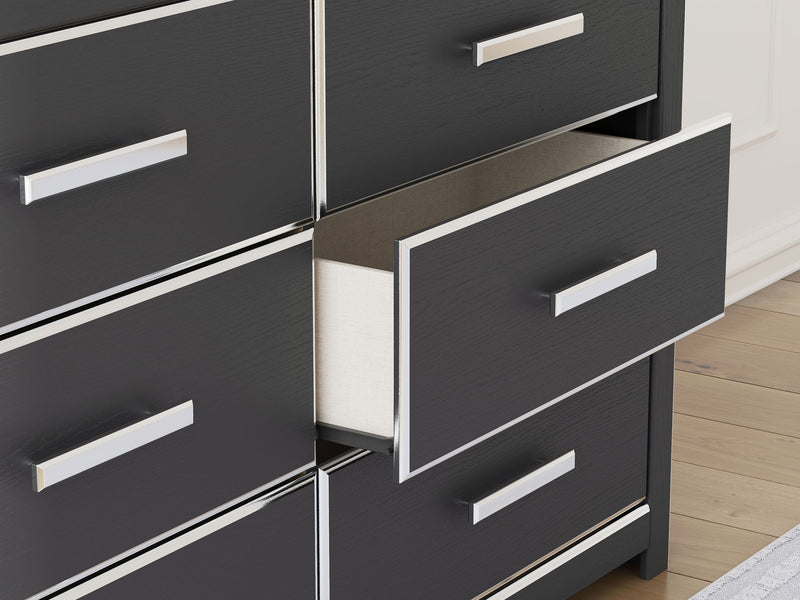 Six-drawer dresser close-up showing dark drawer fronts and white bar pulls