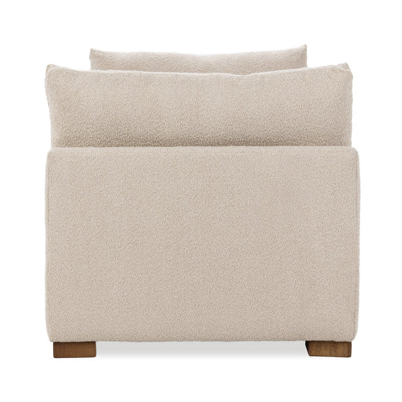 Upholstered daybed end view, textured light beige fabric, back cushion and wooden legs