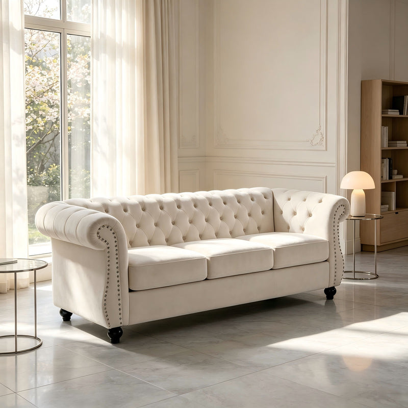 Beige three-seat button-tufted sofa with rolled arms and nail-trimmed edges