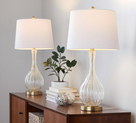 Set of 2 table lamps with white shades and clear glass urn bases, gold-toned accents.