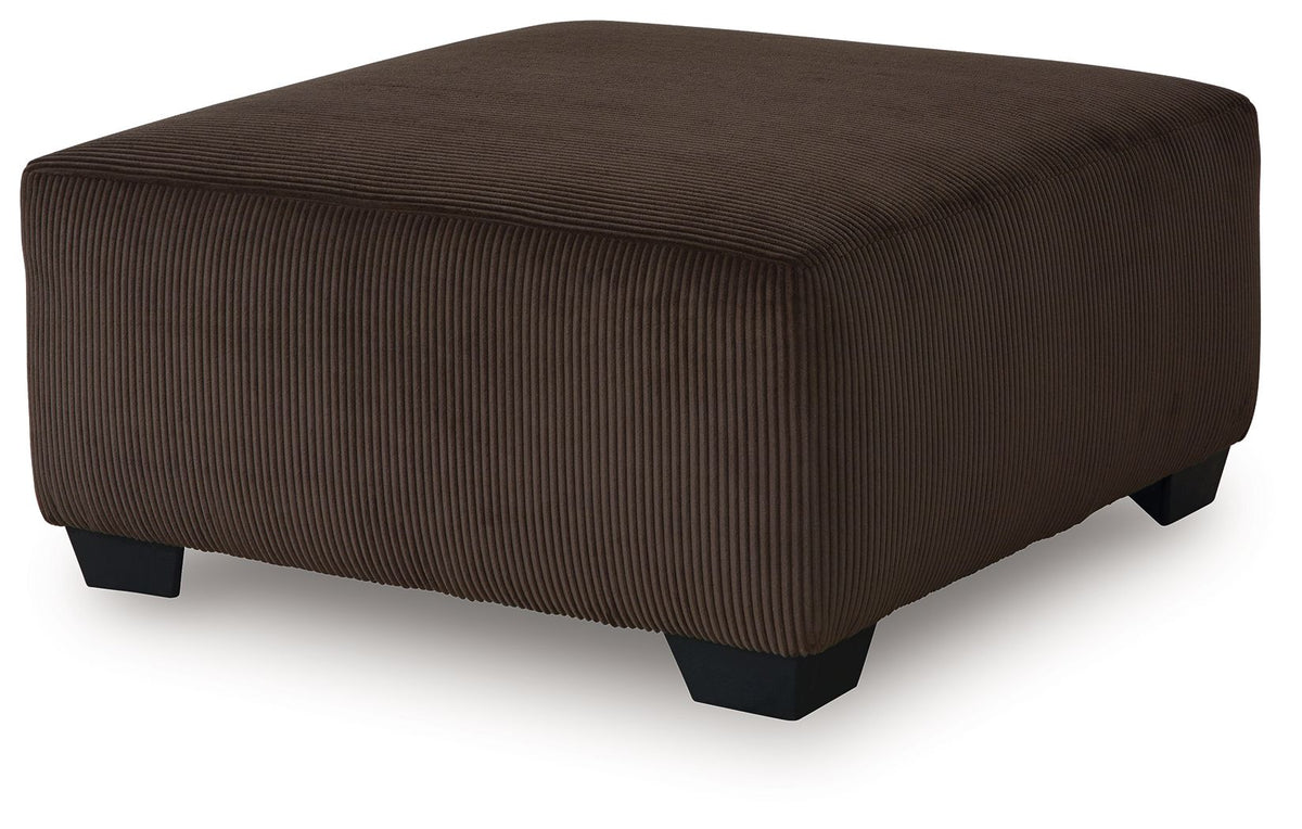 Dark brown ottoman seat with vertical ribbed fabric upholstery and tapered side profile