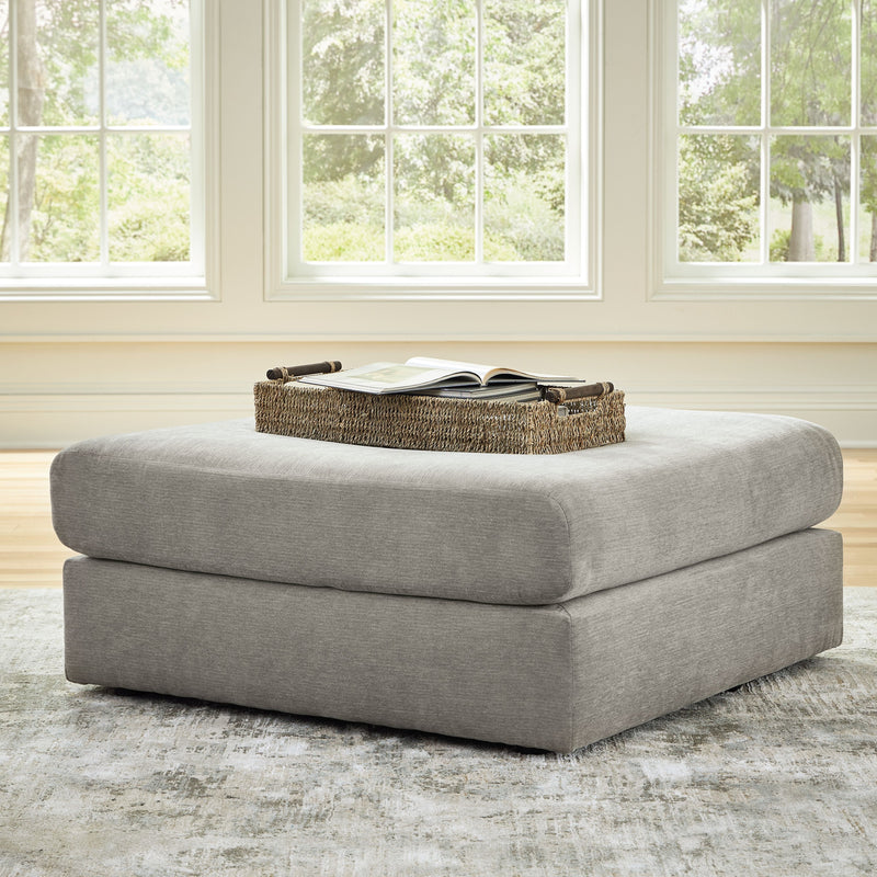 Ash gray upholstered ottoman with padded top and short legs