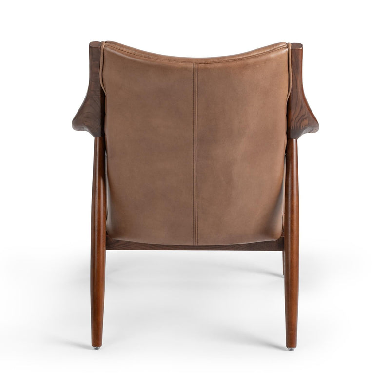 Adobe tan leather club chair back view with vertical seam panel and wood legs
