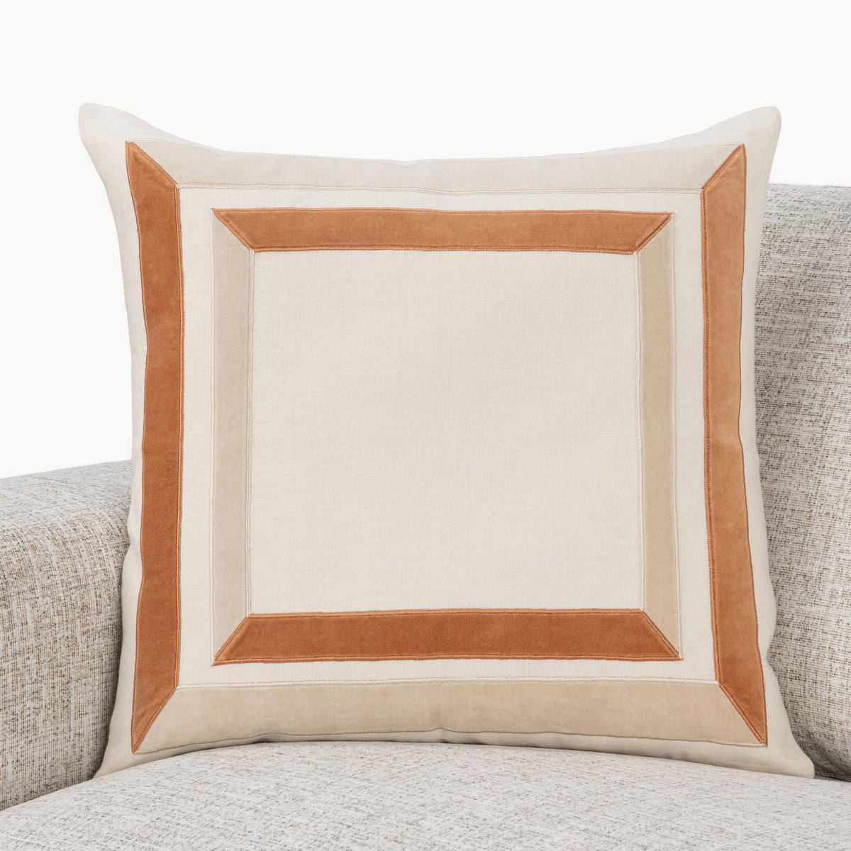 22x22 ivory pillow with tan geometric square frame inset