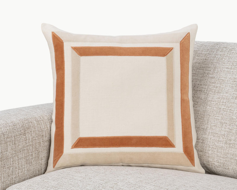 22x22 ivory pillow with tan geometric square frame inset