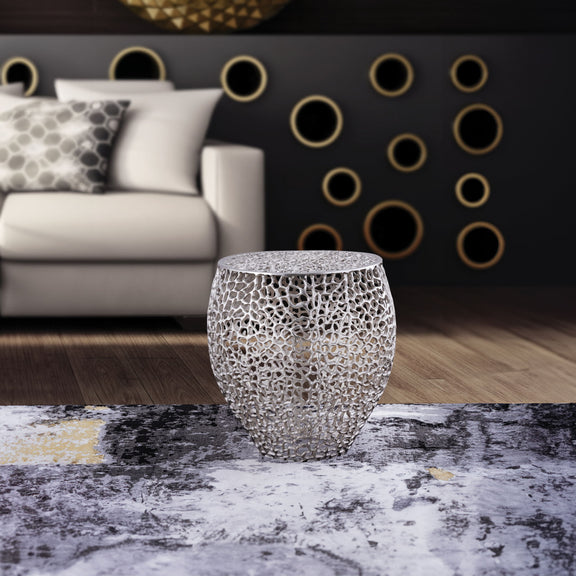 Silver lattice side table with a rounded shape and flat top