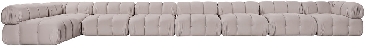 Light gray velvet L-shaped sectional sofa with deep tufting and rounded cushions.