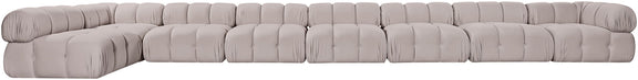 Light gray velvet L-shaped sectional sofa with deep tufting and rounded cushions.