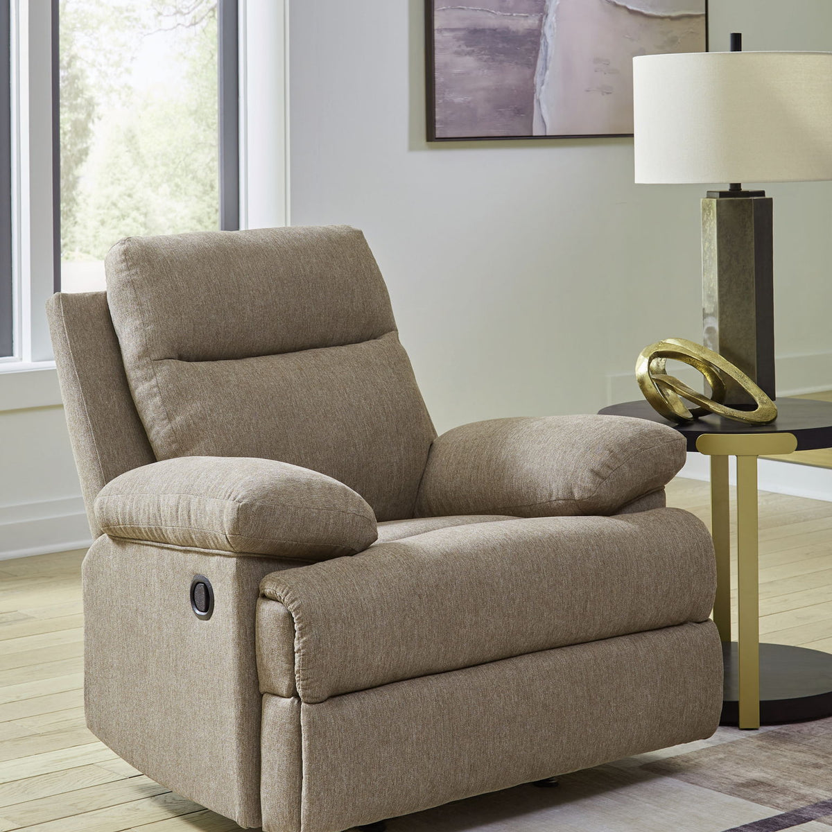 Beige fabric rocker recliner with padded headrest, rounded arms, and side control lever.