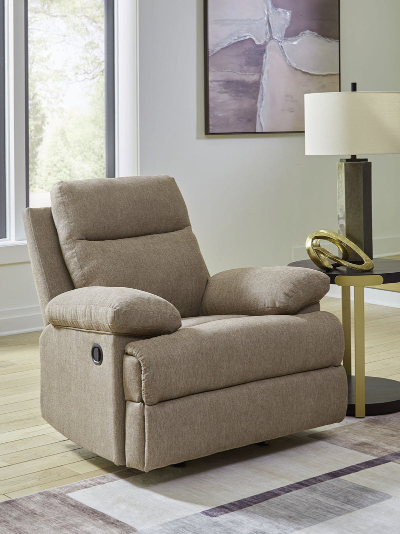 Beige fabric rocker recliner with padded headrest, rounded arms, and side control lever.